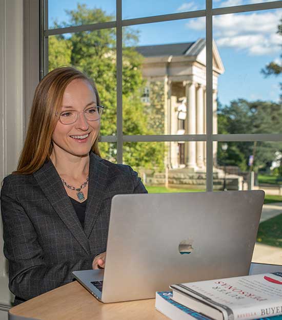Faculty member on a computer working