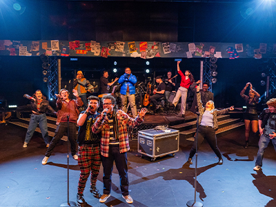 Helen Hammerschmidt and Rita Patel-Eng receive Civic50 award standing in front of Civic50 banner