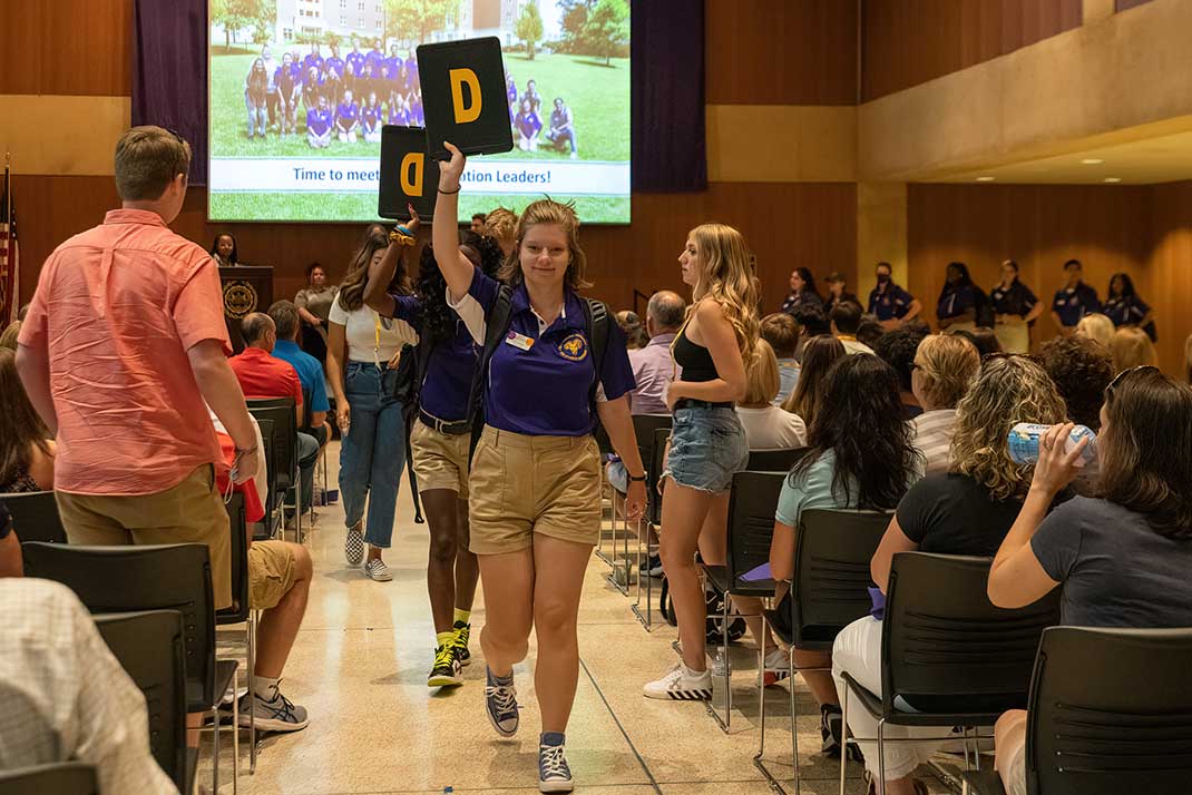 Orientation leaders with signs