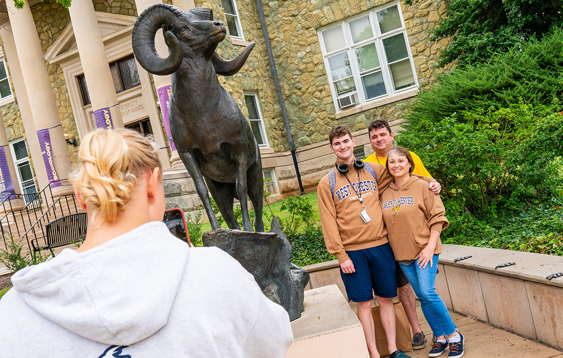 Family in front of ram statue
