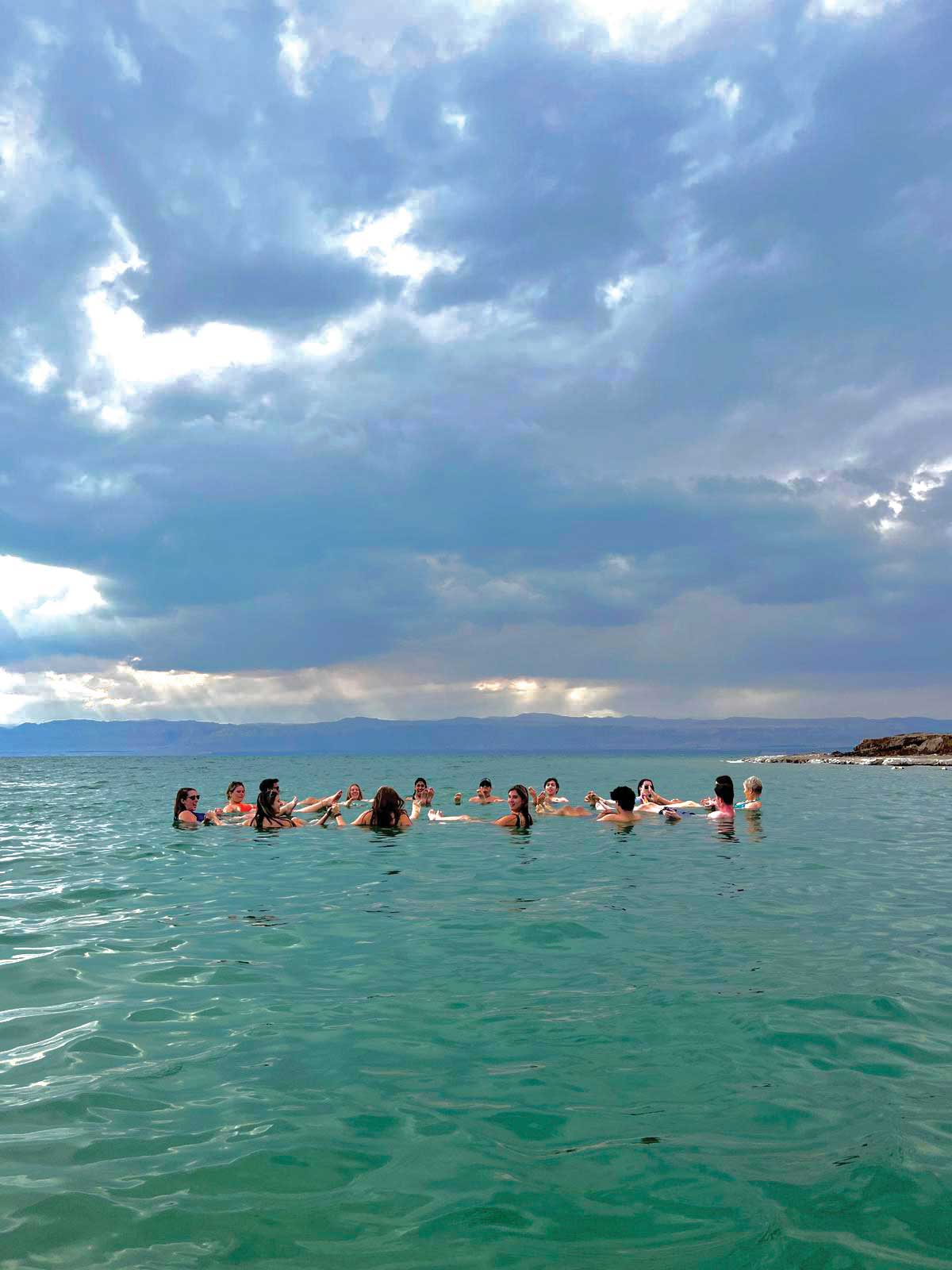 Study Abroad Students in a group swimming in beautiful blue water