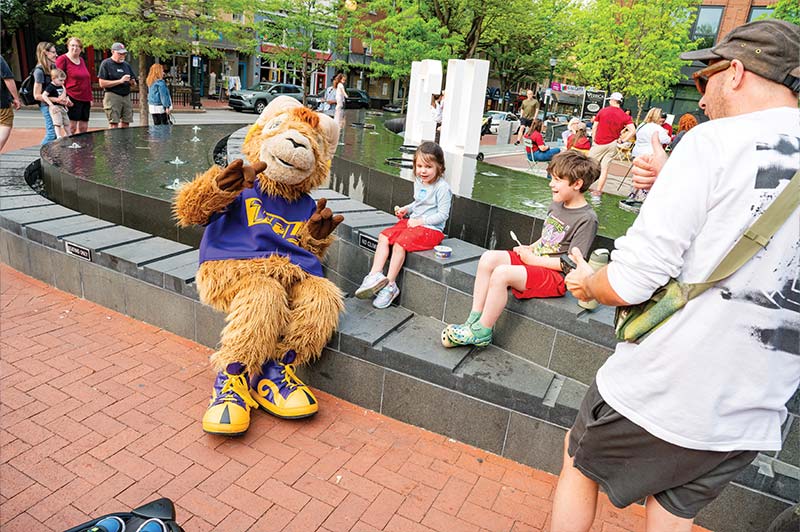 Rammy sits on the fountain with two children