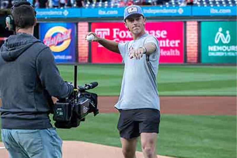 Close up photo of Jake Welsch throwing the first pitch