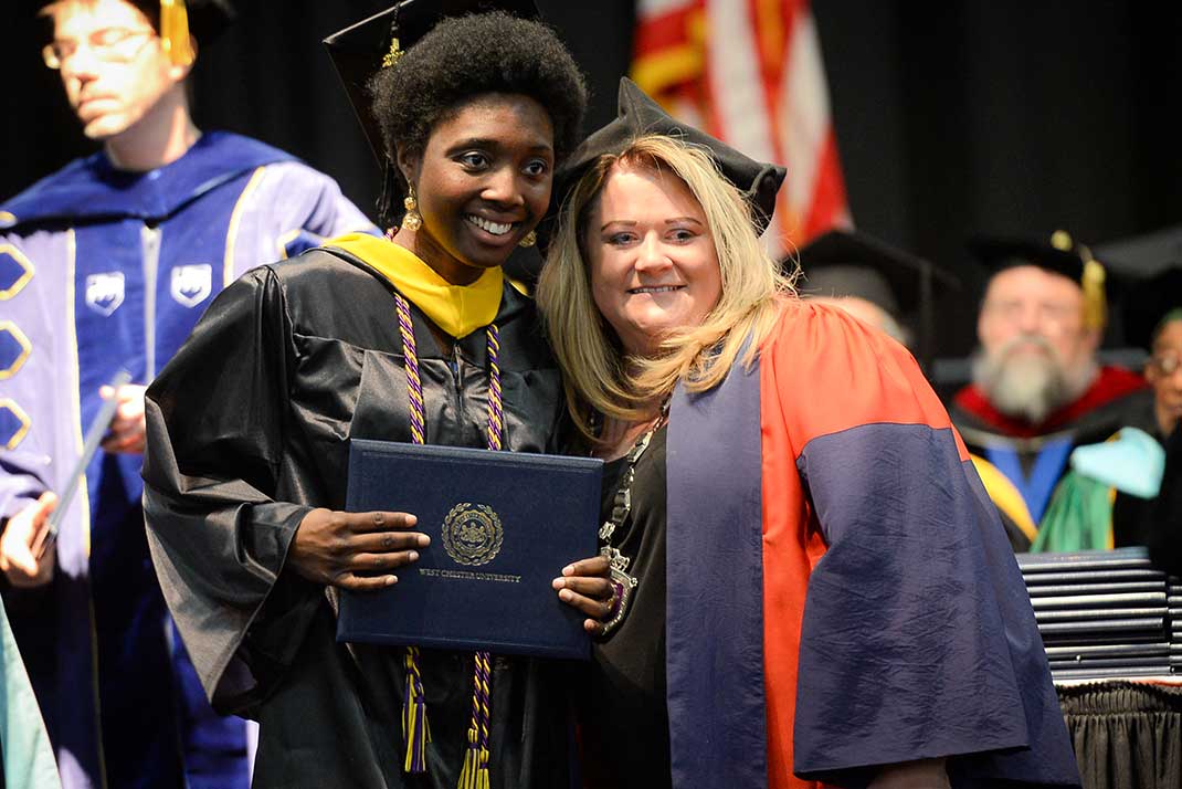 President Bernotsky with student at commencement