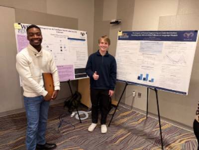 Kadin Matotek and Chrisam Ndlovu in front of their posters at the CSM Fall Poster Event